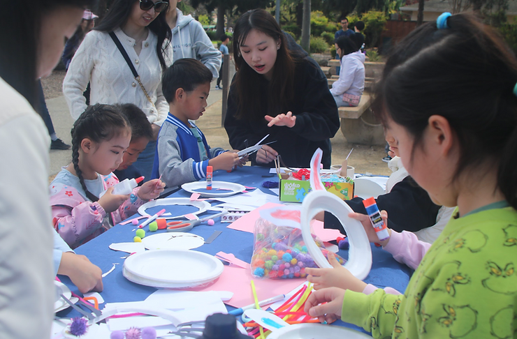 Grace Huang guiding a boy through the project