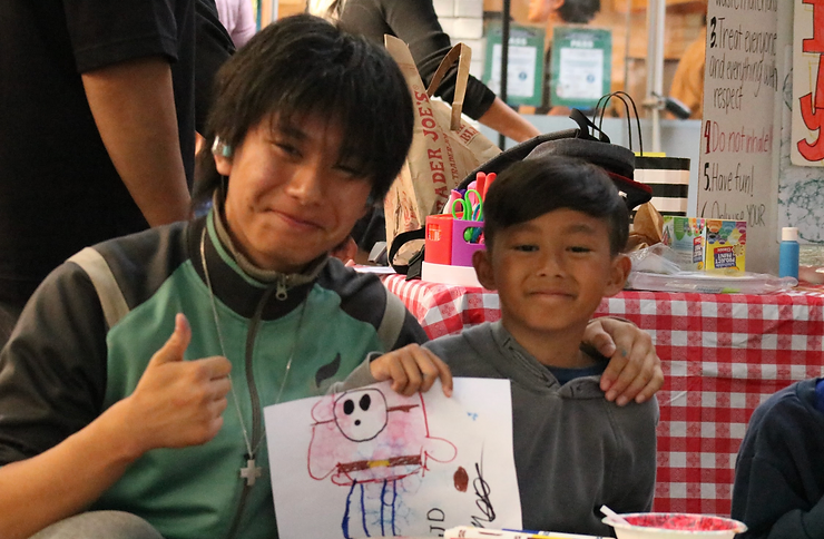 Nathan Nguyen and his student proudly holding up their bubble art